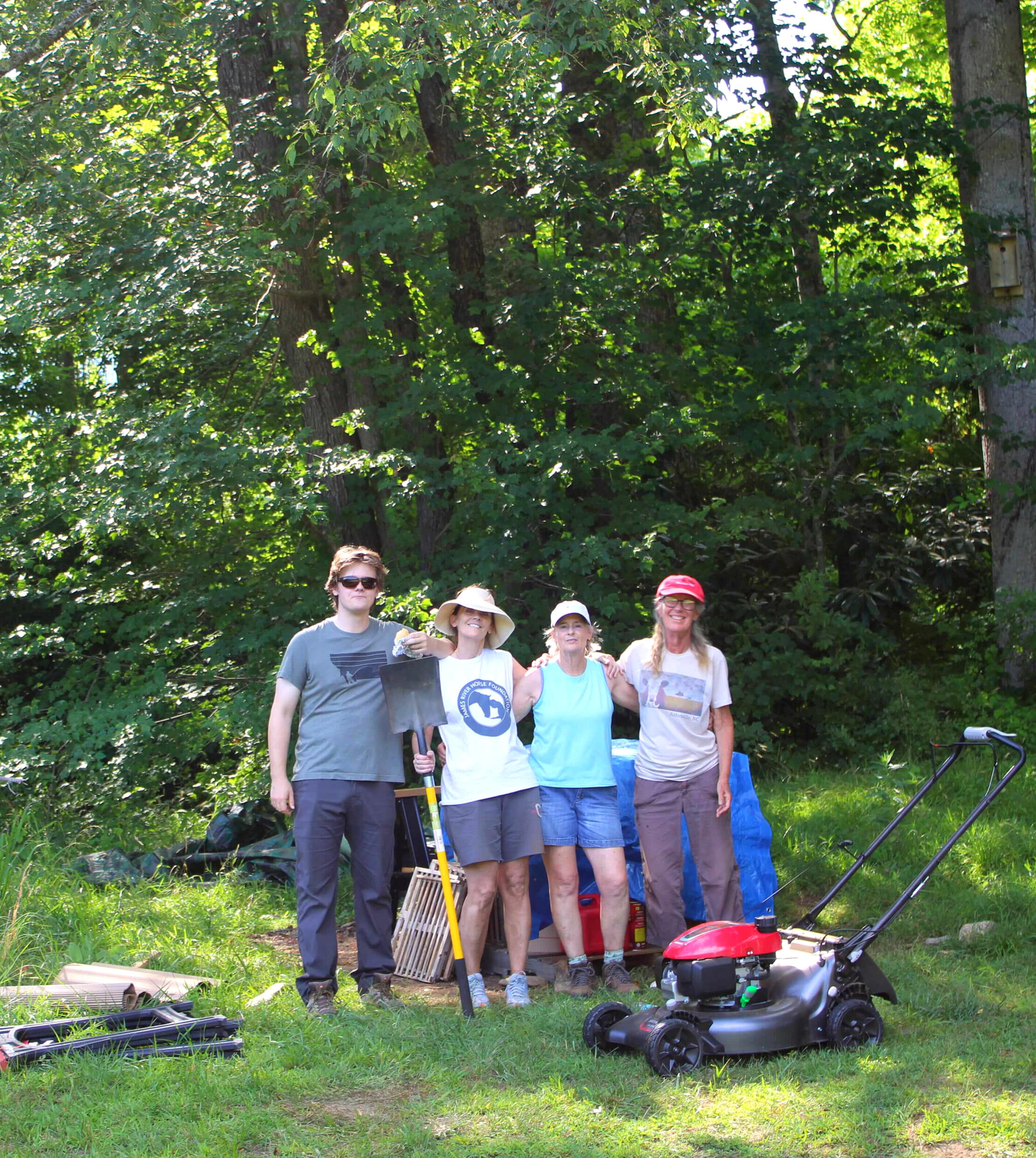 Small group of visitors and farmers during a farm tour at Field Afar Herbs, surrounded by woodland in North Carolina